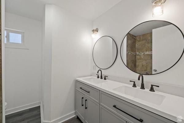 756 E 3rd St S, Ogden, UT 84404 - full bath with double vanity, wood finished floors, baseboards, and a sink
