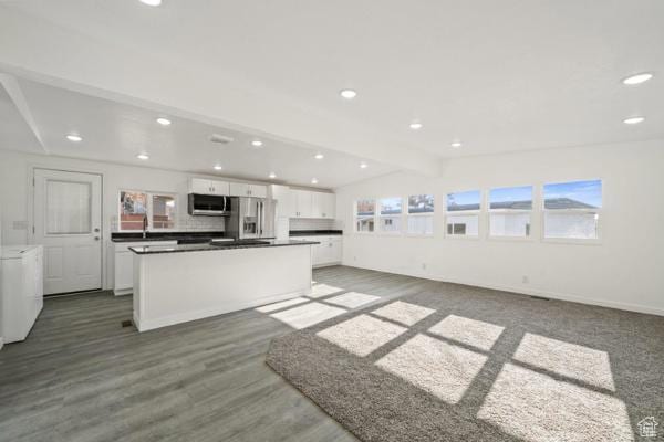 756 E 3rd St S, Ogden, UT 84404 - kitchen with lofted ceiling with beams, appliances with stainless steel finishes, a center island, white cabinets, and recessed lighting