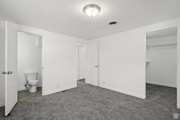 756 E 3rd St S, Ogden, UT 84404 - unfurnished bedroom with baseboards, visible vents, a spacious closet, and carpet flooring