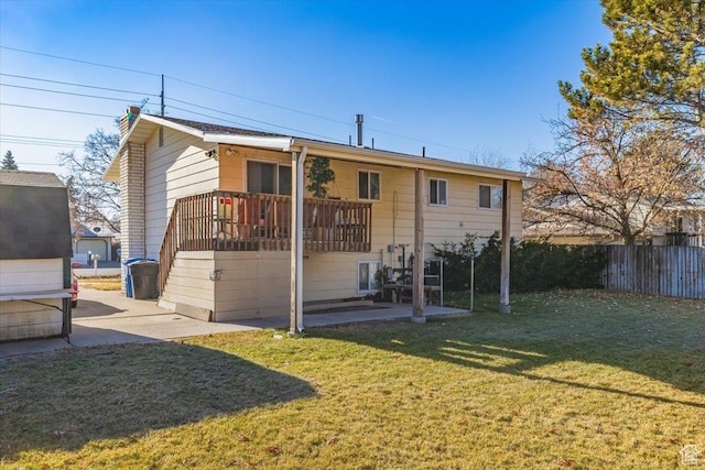 back of house featuring a patio and a lawn