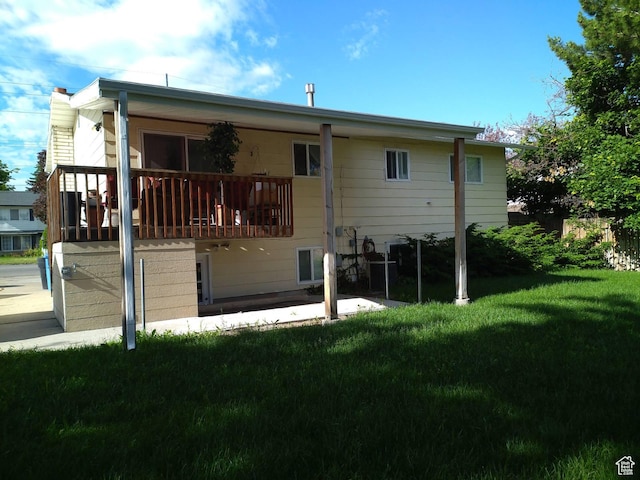 back of house featuring a patio area and a yard
