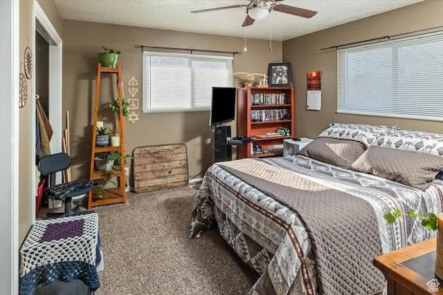 bedroom featuring carpet, ceiling fan, and a textured ceiling