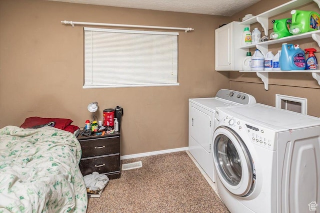 laundry room with washer and clothes dryer, cabinets, a textured ceiling, and light carpet