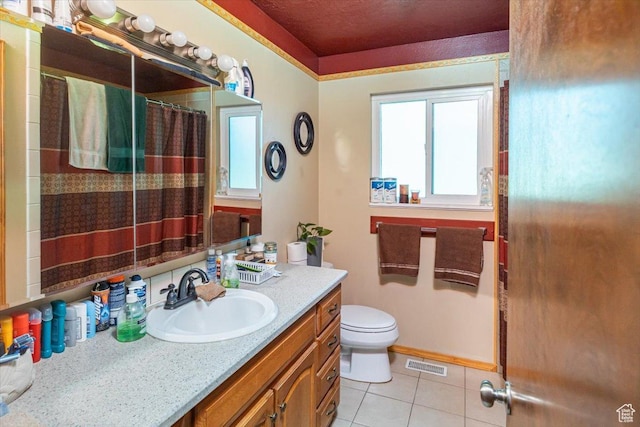 bathroom featuring toilet, vanity, tile patterned floors, and curtained shower