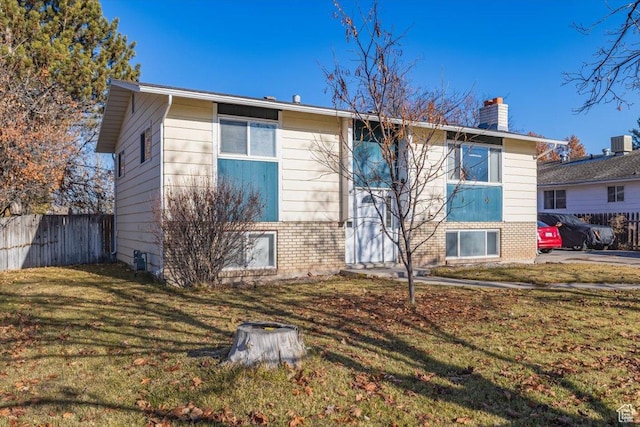 view of front of home with central AC and a front lawn