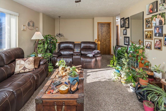 carpeted living room with a textured ceiling and ceiling fan