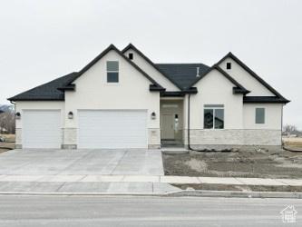 308 E Prestwick Ln, Stansbury Park, UT 84074 - view of front of home featuring driveway and an attached garage