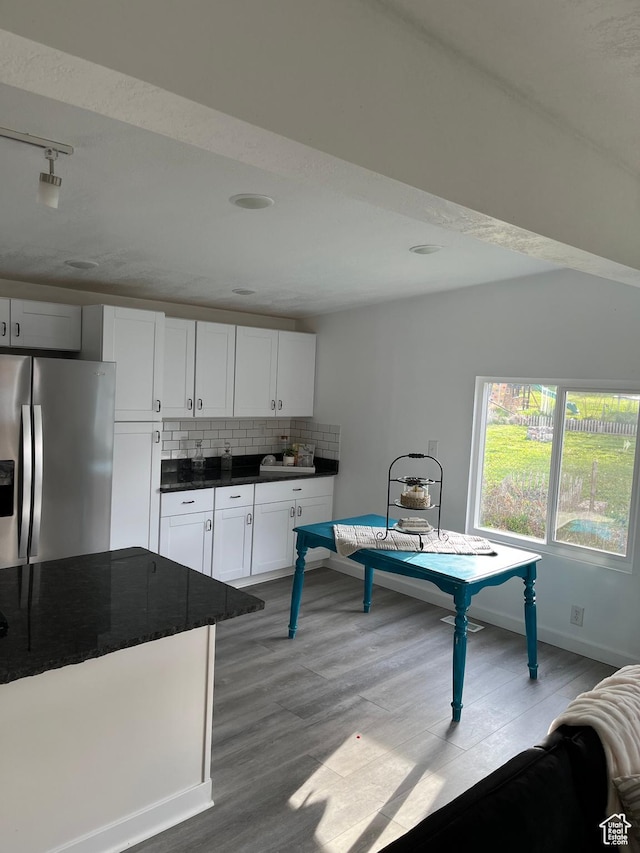 758 E 3rd St S, Ogden, UT 84404 - kitchen featuring stainless steel refrigerator with ice dispenser, dark countertops, backsplash, wood finished floors, and baseboards