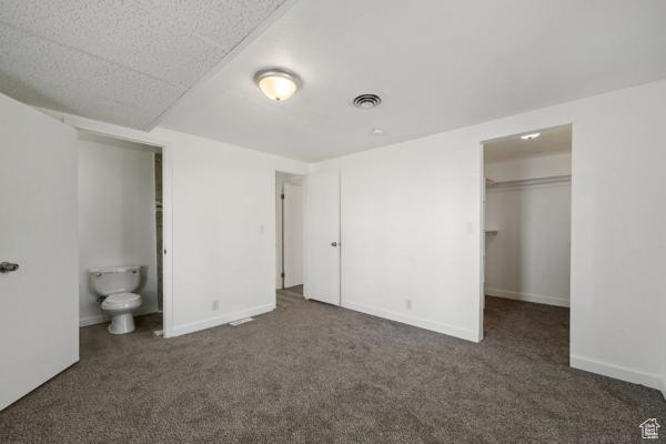 758 E 3rd St S, Ogden, UT 84404 - unfurnished bedroom featuring carpet flooring, a spacious closet, a closet, and baseboards