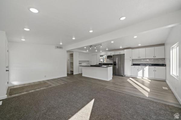 758 E 3rd St S, Ogden, UT 84404 - kitchen featuring appliances with stainless steel finishes, dark countertops, open floor plan, white cabinets, and recessed lighting