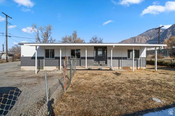 758 E 3rd St S, Ogden, UT 84404 - ranch-style home featuring a porch, a mountain view, and board and batten siding