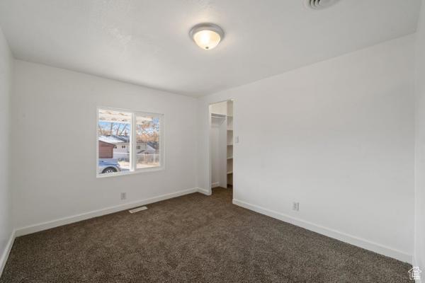 758 E 3rd St S, Ogden, UT 84404 - empty room with dark colored carpet and baseboards