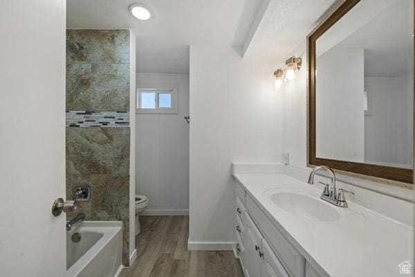 758 E 3rd St S, Ogden, UT 84404 - bathroom featuring toilet, vanity, wood finished floors, tub / shower combination, and baseboards