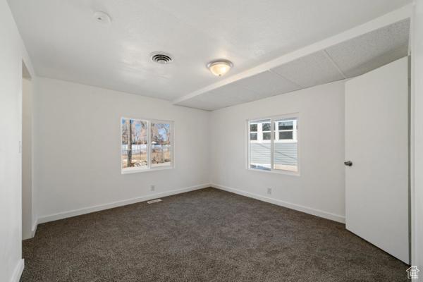758 E 3rd St S, Ogden, UT 84404 - spare room with dark colored carpet and baseboards