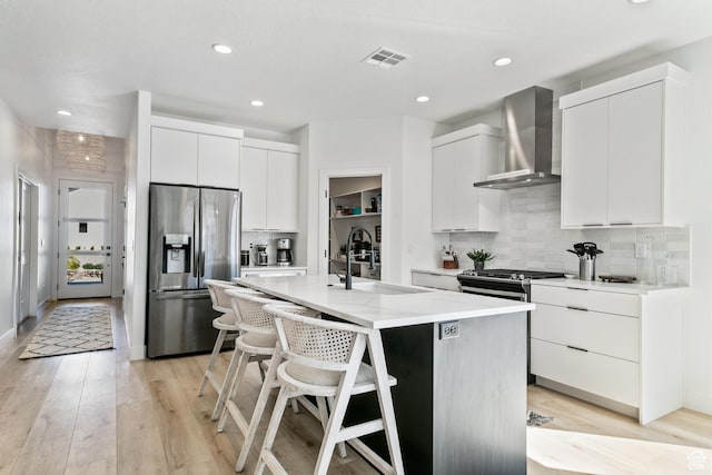1823 W 180 N Street N, Hurricane, UT 84737 - kitchen with appliances with stainless steel finishes, sink, wall chimney range hood, white cabinets, and an island with sink