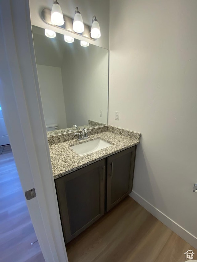 bathroom featuring hardwood / wood-style flooring and vanity
