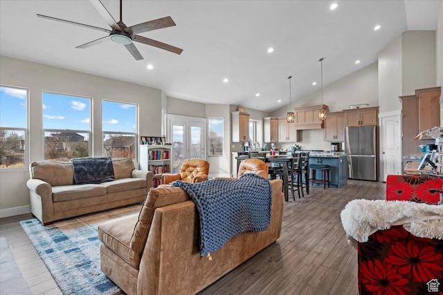 living room with ceiling fan, high vaulted ceiling, and light hardwood / wood-style flooring