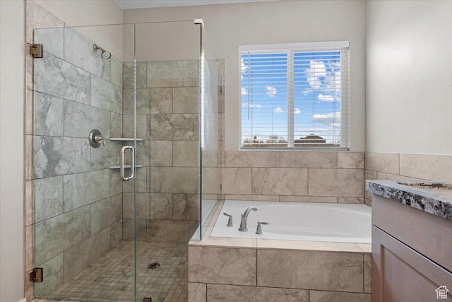 bathroom featuring vanity and shower with separate bathtub
