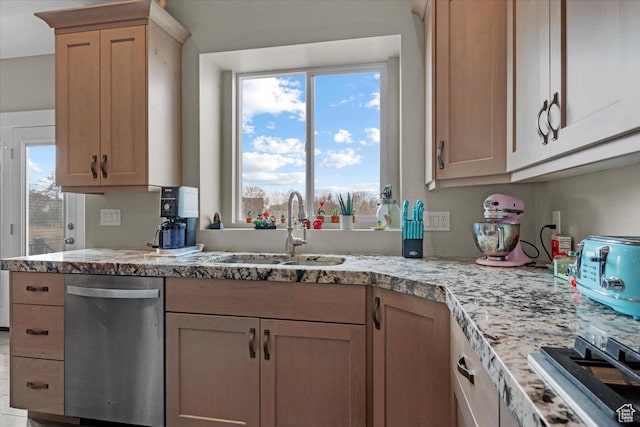 kitchen featuring dishwasher, light brown cabinets, and sink