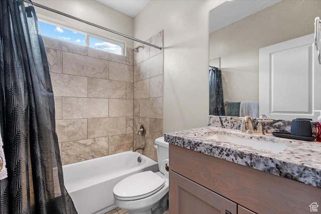 full bathroom with vanity, shower / tub combo, and toilet