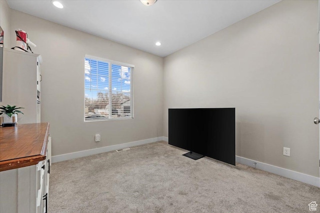 interior space featuring light carpet