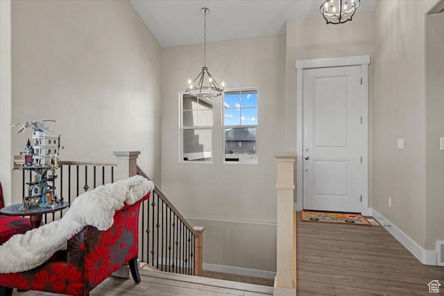foyer featuring hardwood / wood-style floors and a notable chandelier