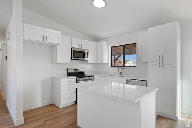 12875 S Aspen Cir, Riverton, UT 84065 - kitchen featuring a center island, lofted ceiling, white cabinets, sink, and appliances with stainless steel finishes