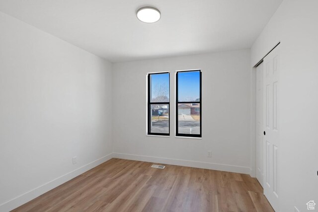 12875 S Aspen Cir, Riverton, UT 84065 - unfurnished bedroom with light wood-style floors, a closet, and baseboards