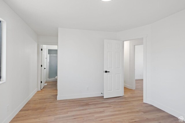 12875 S Aspen Cir, Riverton, UT 84065 - unfurnished bedroom with baseboards and light wood-style flooring