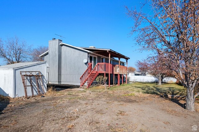 12875 S Aspen Cir, Riverton, UT 84065 - rear view of house with stairway, a chimney, and a wooden deck