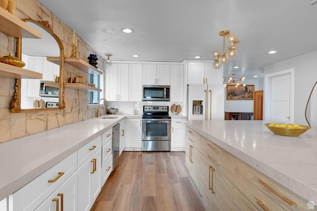 837 E 930 N, Pleasant Grove, UT 84062 - kitchen with sink, white cabinets, hanging light fixtures, and appliances with stainless steel finishes