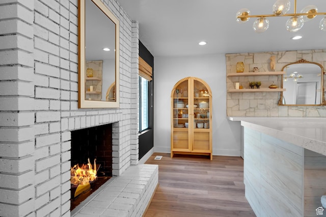 837 E 930 N, Pleasant Grove, UT 84062 - dining space with hardwood / wood-style flooring, an inviting chandelier, and a brick fireplace