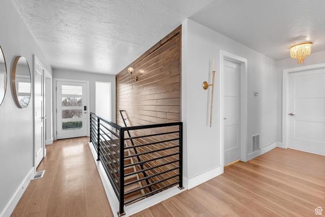 837 E 930 N, Pleasant Grove, UT 84062 - hall with wood walls, a chandelier, a textured ceiling, and light wood-type flooring