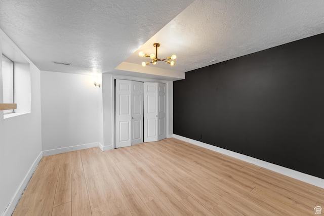 837 E 930 N, Pleasant Grove, UT 84062 - unfurnished bedroom with a closet, light hardwood / wood-style floors, a textured ceiling, and an inviting chandelier