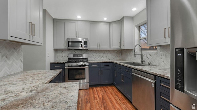 822 N 1120 E, Spanish Fork, UT 84660 - kitchen featuring stainless steel appliances, decorative backsplash, light stone counters, light wood-type flooring, and recessed lighting