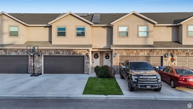 822 N 1120 E, Spanish Fork, UT 84660 - multi unit property with a garage, driveway, roof mounted solar panels, stucco siding, and stone siding