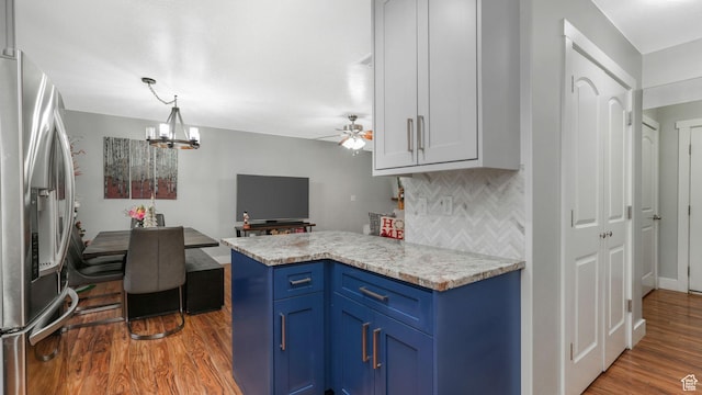 822 N 1120 E, Spanish Fork, UT 84660 - kitchen with blue cabinets, stainless steel refrigerator with ice dispenser, wood finished floors, tasteful backsplash, and light countertops