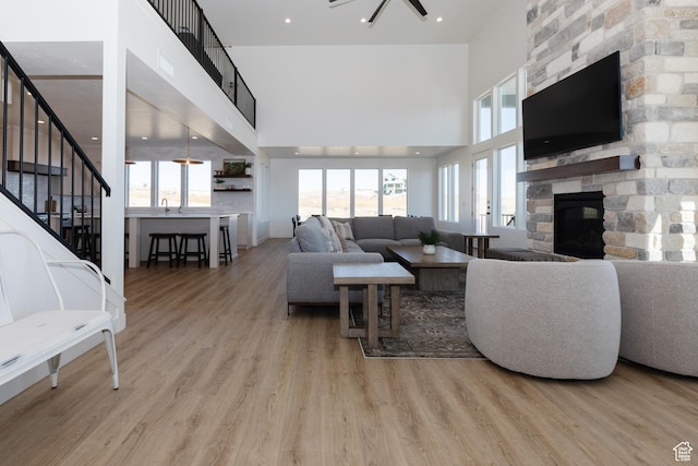 470 Lotus Dr Unit 149, Fish Haven, ID 83287 - living area featuring a high ceiling, a fireplace, stairway, and wood finished floors