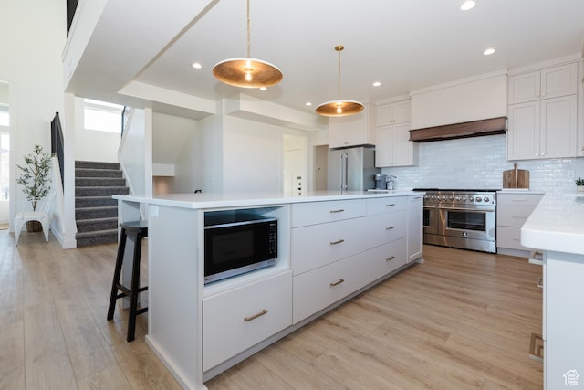 470 Lotus Dr Unit 149, Fish Haven, ID 83287 - kitchen featuring high quality appliances, light countertops, backsplash, light wood-type flooring, and white cabinets