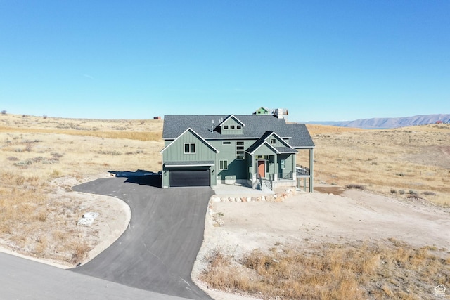470 Lotus Dr Unit 149, Fish Haven, ID 83287 - view of front of home featuring board and batten siding, a garage, asphalt driveway, and covered porch