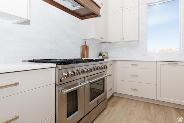 470 Lotus Dr Unit 149, Fish Haven, ID 83287 - kitchen with range with two ovens, decorative backsplash, light wood finished floors, and white cabinets