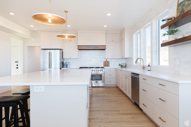 470 Lotus Dr Unit 149, Fish Haven, ID 83287 - kitchen featuring premium appliances, a sink, tasteful backsplash, a kitchen bar, and recessed lighting