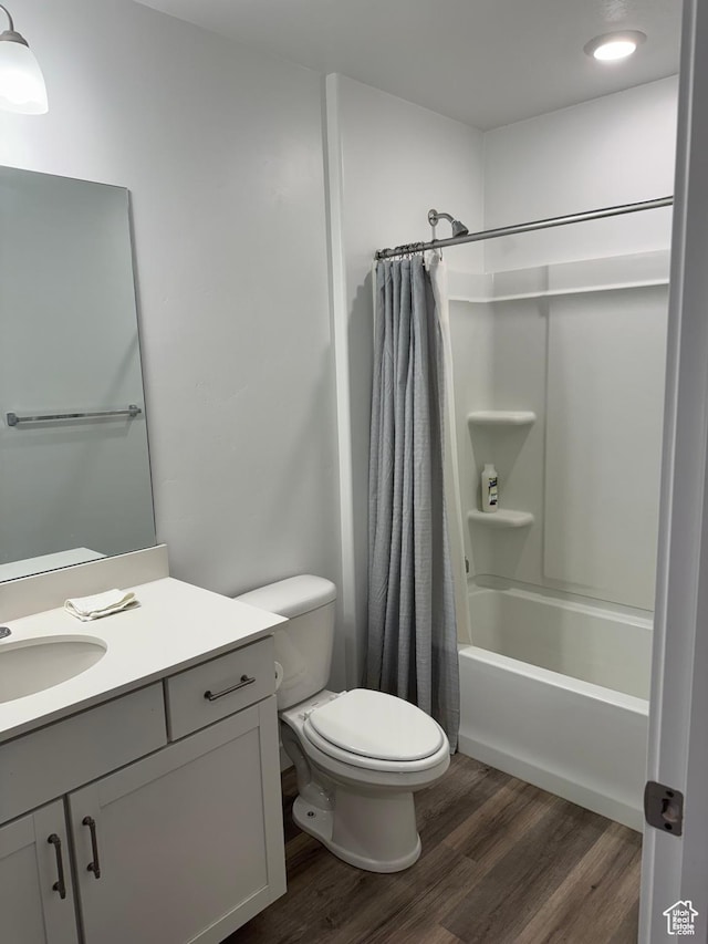 full bathroom featuring vanity, toilet, wood-type flooring, and shower / tub combo with curtain