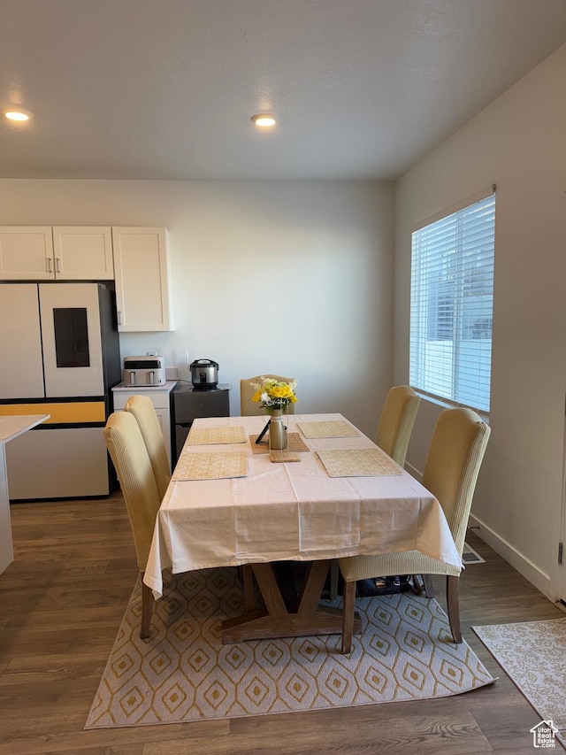 dining space with dark wood-type flooring
