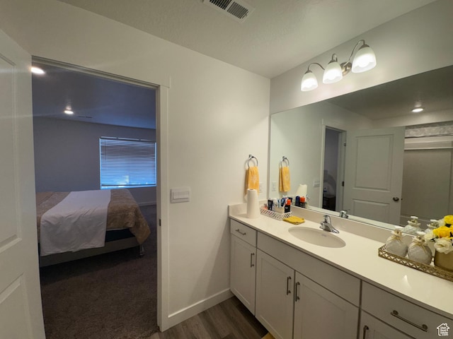 bathroom featuring hardwood / wood-style flooring and vanity
