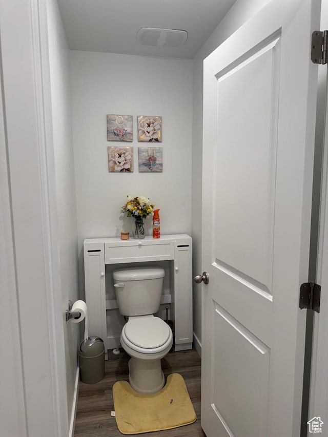bathroom featuring hardwood / wood-style floors and toilet