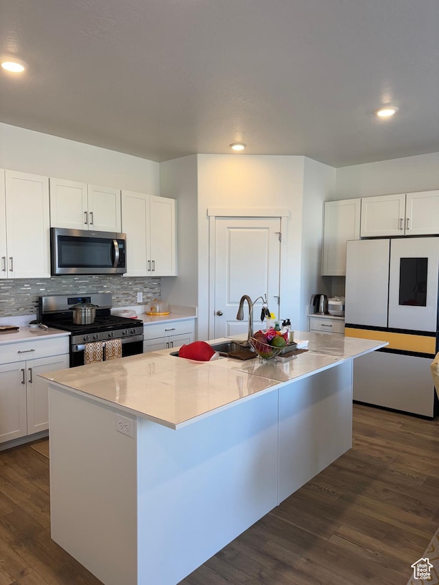 kitchen with white cabinets, sink, an island with sink, and appliances with stainless steel finishes