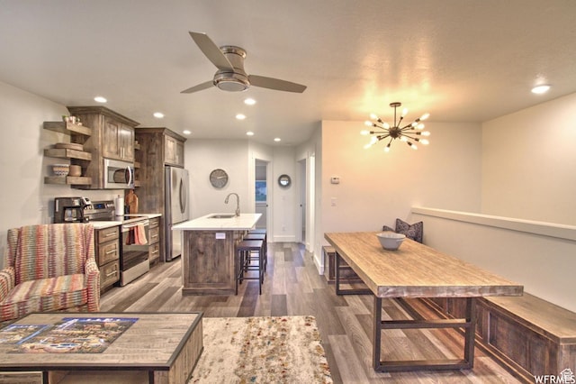 55 W Buttercup Ln Unit 33, Garden City, UT 84028 - kitchen with sink, dark wood-type flooring, stainless steel appliances, a center island with sink, and dark brown cabinets