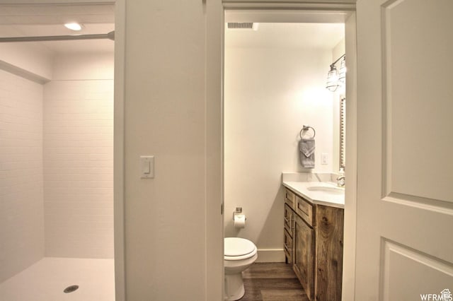 55 W Buttercup Ln Unit 33, Garden City, UT 84028 - bathroom featuring hardwood / wood-style floors, vanity, toilet, and tiled shower
