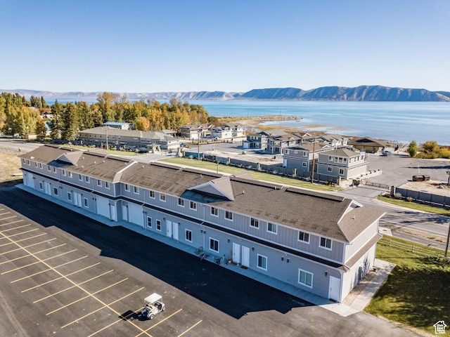 drone / aerial view featuring a water and mountain view
